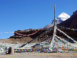 06 Tarboche Pole With Mount Kailash Behind On Mount Kailash Outer Kora The prayer-flag festooned Tarboche (4750m, 08:27) Pole is replaced each year at the major festival of Saga Dawa, marking the enlightenment of Shakyamuni Buddha. If the pole stands absolutely vertical all is well, but if it leans towards Kailash things are not good, if it leans away, things are even worse. Although we started our trek from Darchen, you can drive here too.